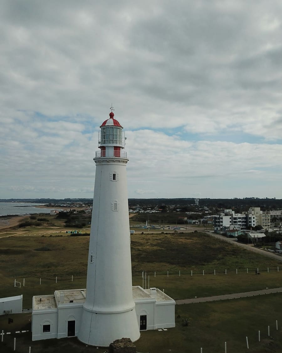 The white lighthouse at Cabo de Santa María in La Paloma, the town behind it